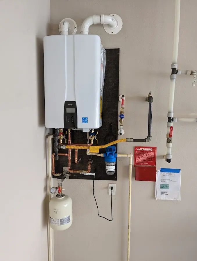 Professional plumber installing copper piping in a Richland home